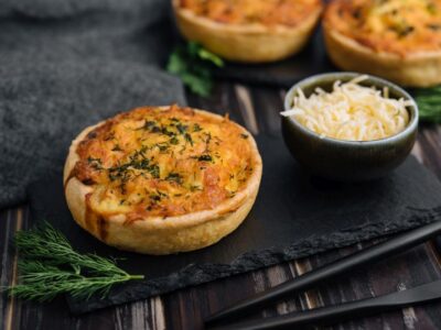 Cheddar cheese and spring onion omelette tarts served on wooden board